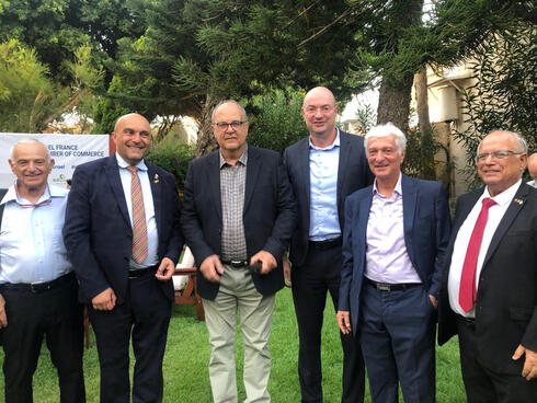 Amb. Frédéric Journès, second from left, and Julien Roitman, second from right, with other attendees. 