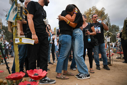 Mourners gather at the site of the Nova massacre to commemorate victims. 