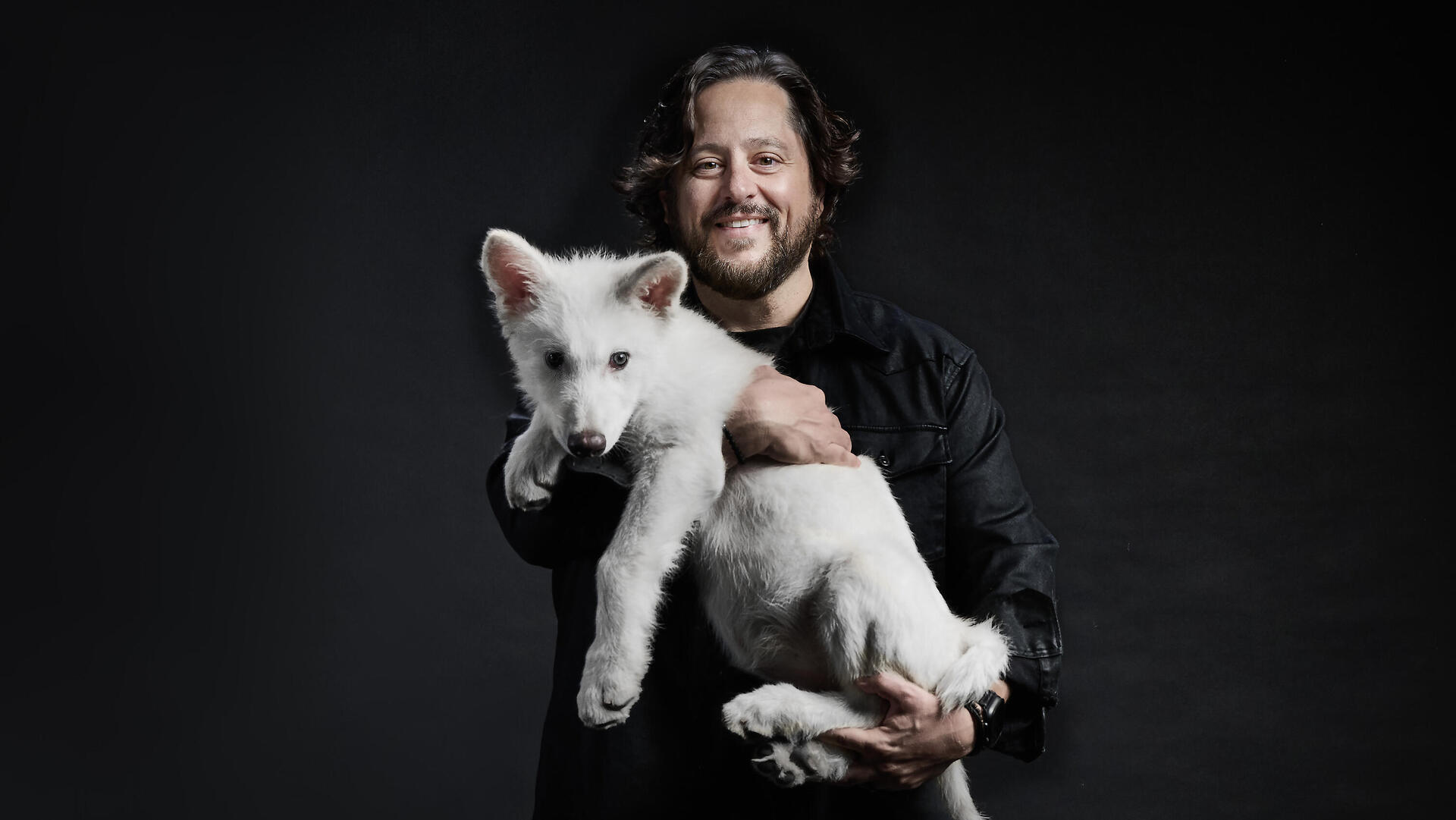 Sam Lamm holding Romulus, one of the cubs