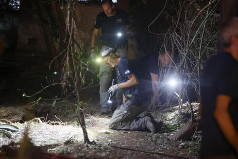 Bomb squad searches for remains of bomb that fell in Ginaton from a missile launch from Yemen. 