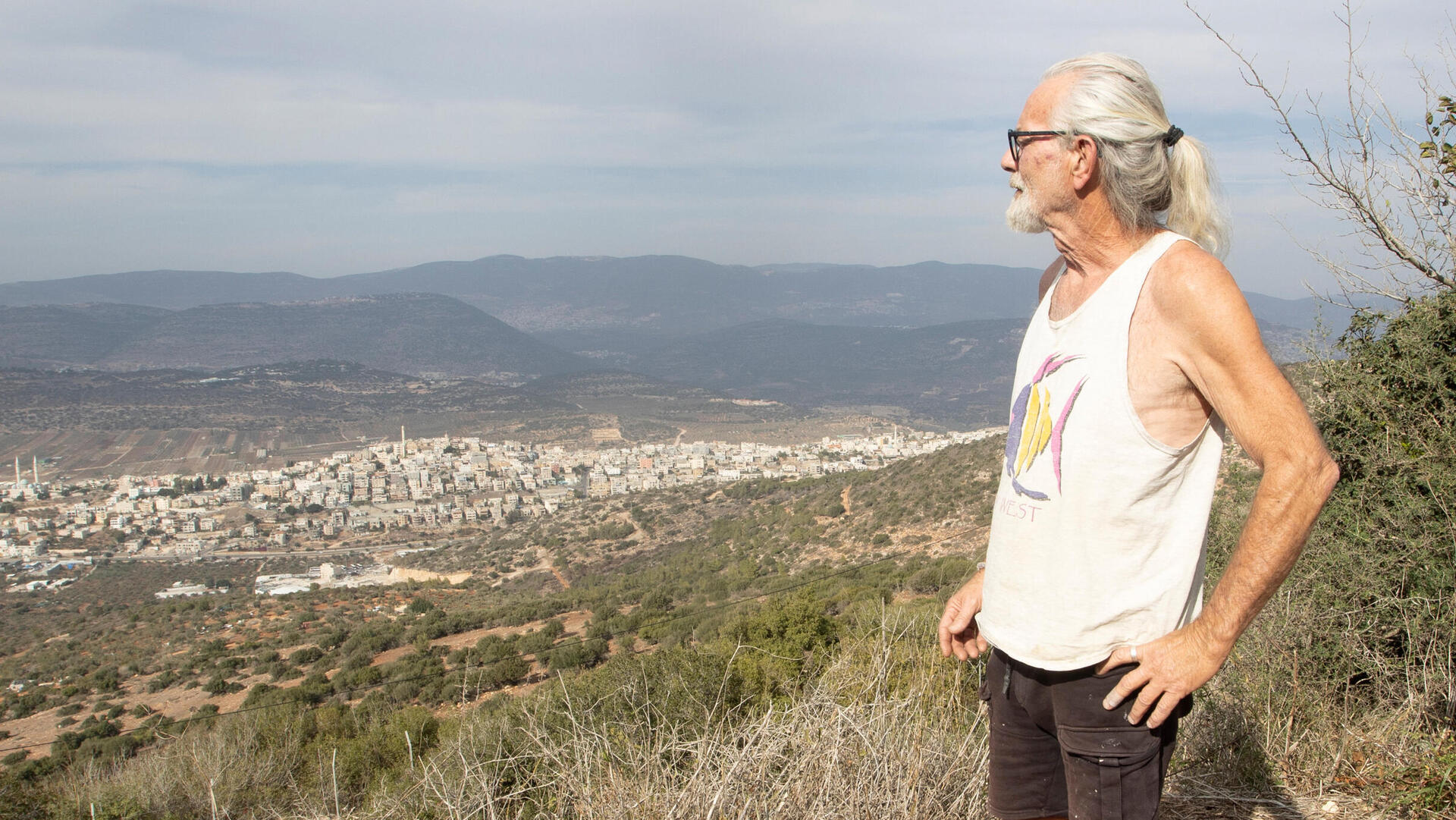 מוטי פולק משקיף על עראבה מביתו בקיבוץ יחד. "אנחנו חיים פה בתוך מציאות של ירי רציף ואני כבר יודע לזהות את הקולות: מתי זה רימון, מתי זה ירי של מא"ג, מתי זה רק ירי מאקדח"