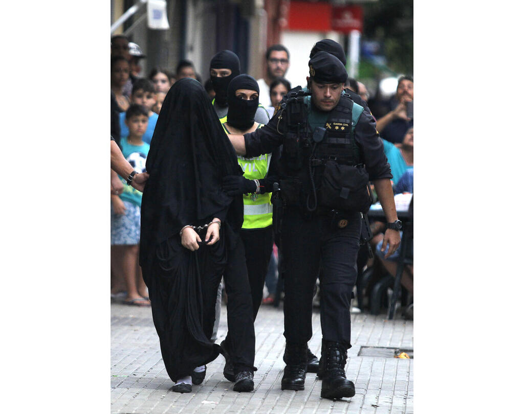 משטרת ספרד עוצרת בת 18 שחשודה בגיוס מתנדבים לדאעש, גנדיה, ספרד, 2015. זמיגרוד יצאה למחקר כי "הציקה לי השאלה: מדוע הנערות התפתו ללכת בעקבות אידאולוגיה קיצונית?" (צילום: Jose Jordan/AFP) משטרת ספרד עוצרת בת 18 שחשודה בגיוס מתנדבים לדאעש מוסף