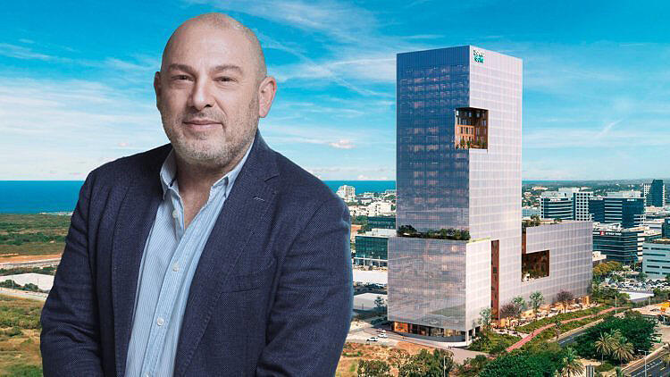 יוסי פרשקובסקי על רקע הדמיה של הפרויקט בהרצליה פיתוח