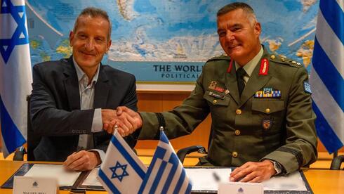 Representatives from Israel and Greece sign a defense deal Representatives from Israel and Greece sign a defense deal