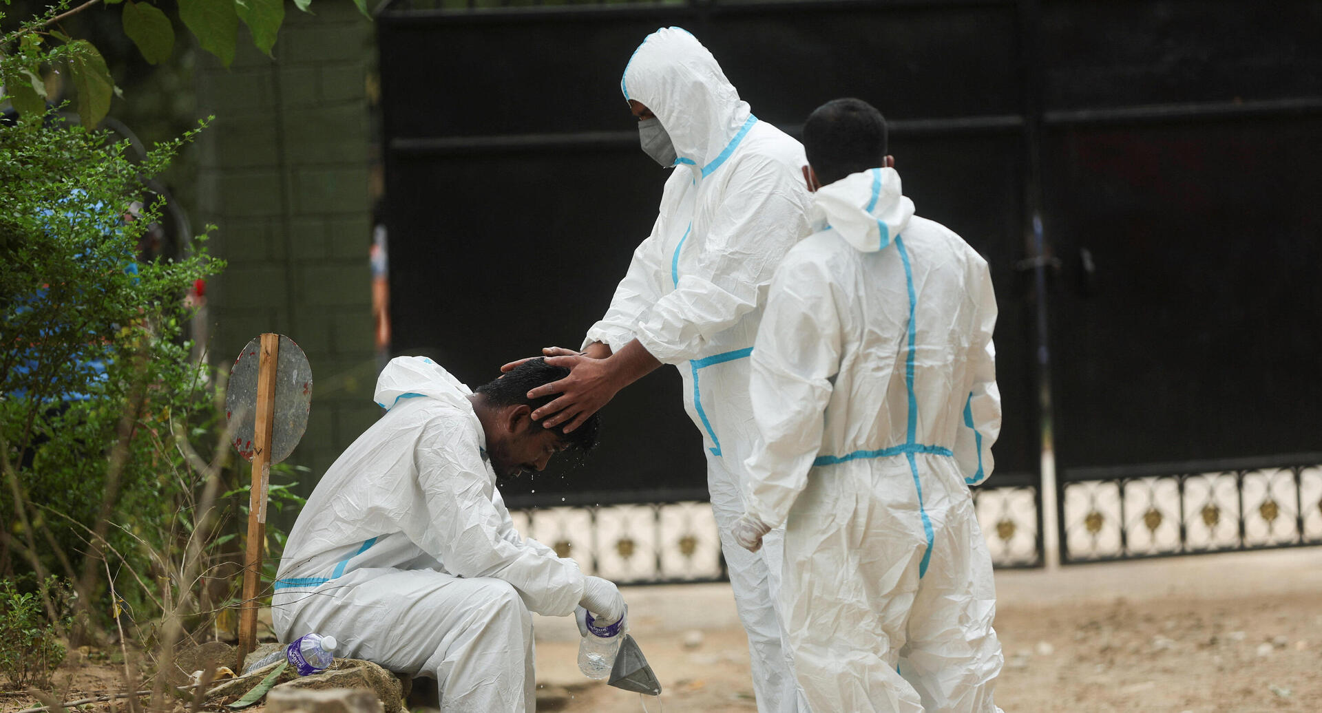 A healthcare worker holds his colleague's head during a break after handing the bodies of victims who perished in the flash floods and a mudslide, at the Maithili Barrack, an army training center, in Trishuli, Nuwakot district, Nepal, September 1, 2026. REUTERS/Francis Mascarenhas 