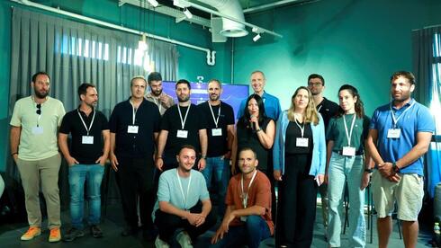 Hilla Ovil-Brenner (holding mic), CEO &amp; founder of ScaleUp House with the startup team  