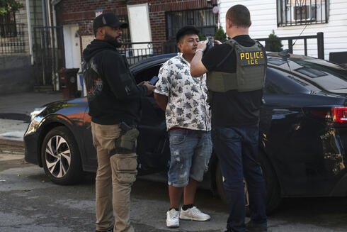 Agents from the U.S. immigration agency (ICE) questioning a suspect. 