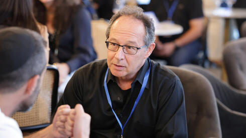 Avi Feldman, a partner at Mobilion Ventures, in conversation with an entrepreneur at the Scale-Up House "speed-dating" event.